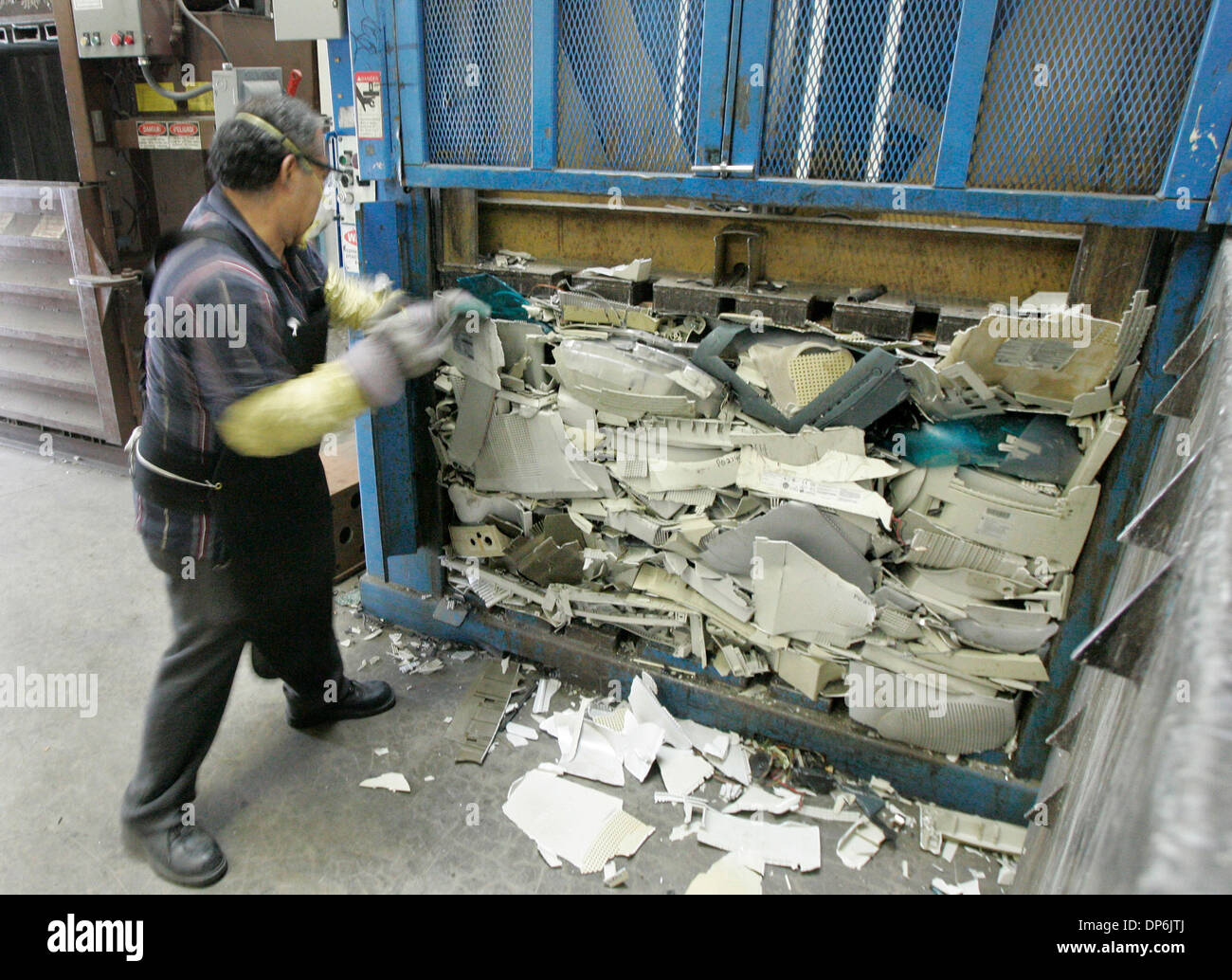 Oct 17, 2006; Rancho Cucamonga, CA, USA; ADOLFO GREGORIO removes a crushed plastic bail from a crusher at Amandi, an e-waste recycling company, on Tuesday in Rancho Cucamonga, California. The plastic bails (which come from computer monitor housings) are crushed into bails so the plastic can be recycled.cycling company, on Tuesday in Rancho Cucamonga, California.  Mandatory Credit:  Stock Photo