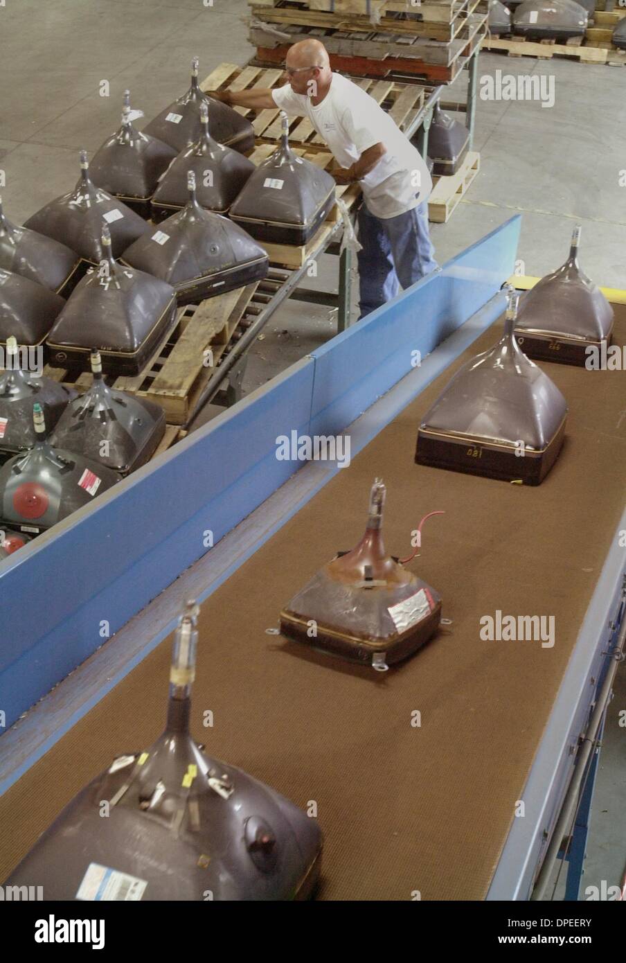 (Published 6/6/2004, N-4; UTS1812197) Craig Rieger the conveyor belt of a CRT crusher, which can crush 65,000 lbs of television tubes and computer monitors an hour. Craig works at the Computer Recyclers of America in Vista.UT/DON KOHLBAUER Stock Photo