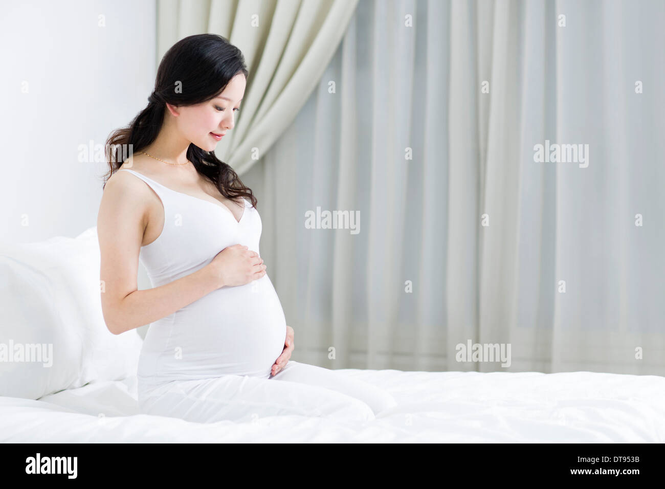 Pregnant woman holding her belly Stock Photo - Alamy