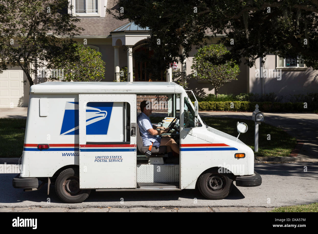 Postal Delivery Van with USPS Mail Carrier, USA Stock Photo