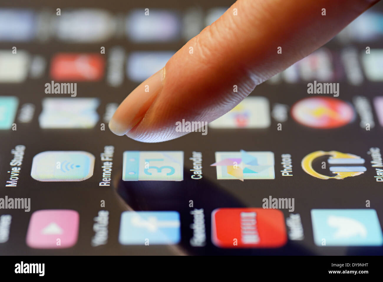 Tablet App Being Selected by a Finger on the Touchscreen, Close Up. Stock Photo