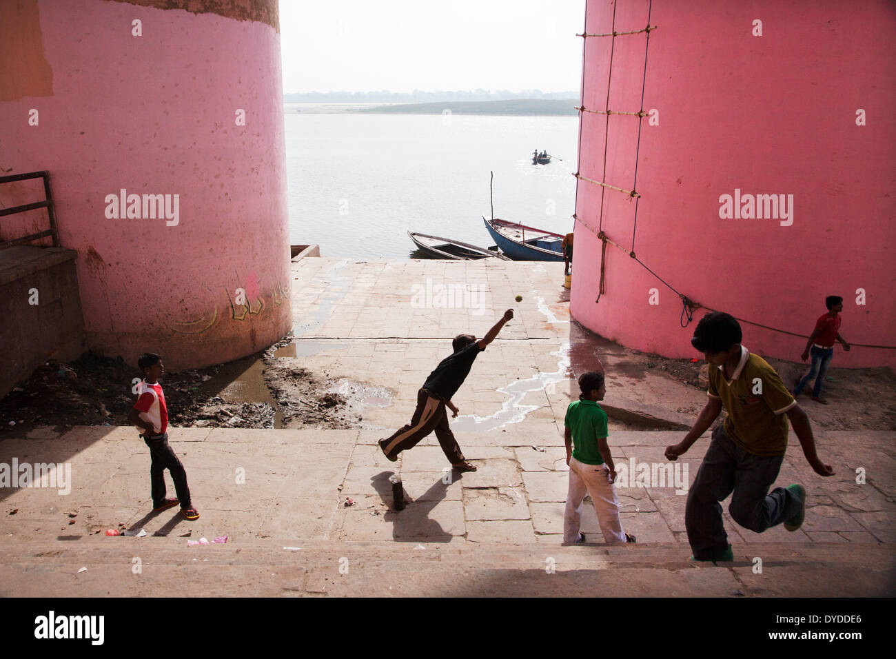 Boys playing cricket beside the Ganges river. Stock Photo