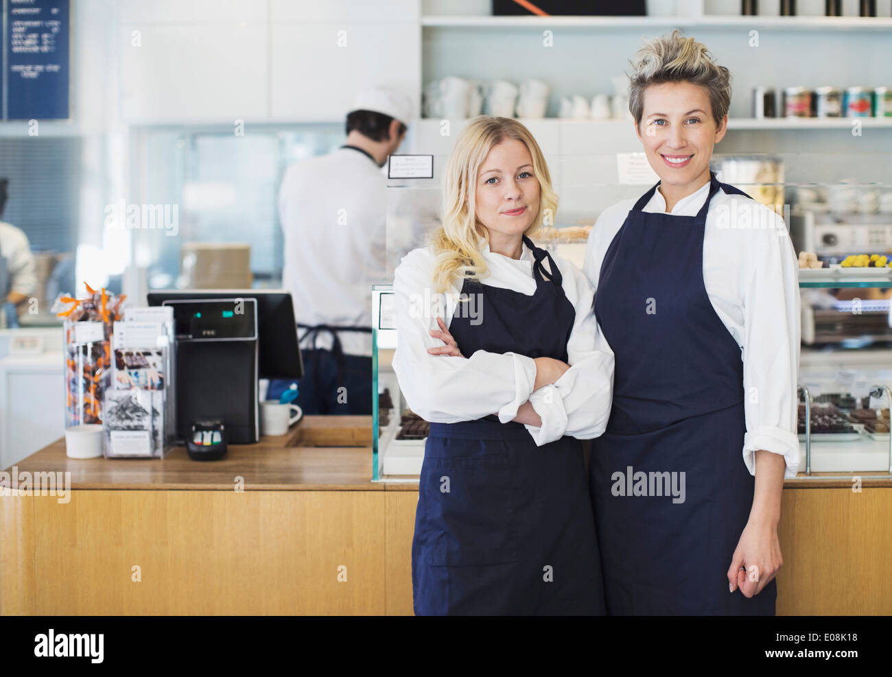 Portrait of confident female workers standing in cafe Stock Photo