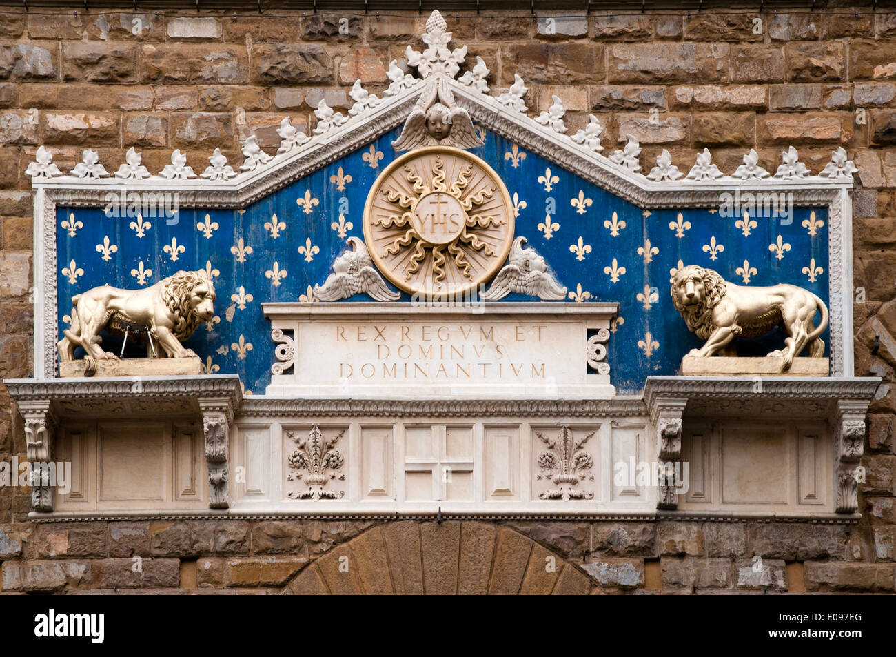 Marble frontispiece of 1528 with two gilded lions on Palazzo Vecchio Florence Italy There is a glory and the monogram of Christ Stock Photo