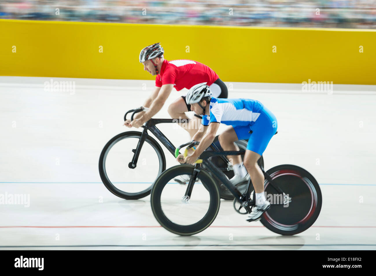 Track cyclists racing in velodrome Stock Photo