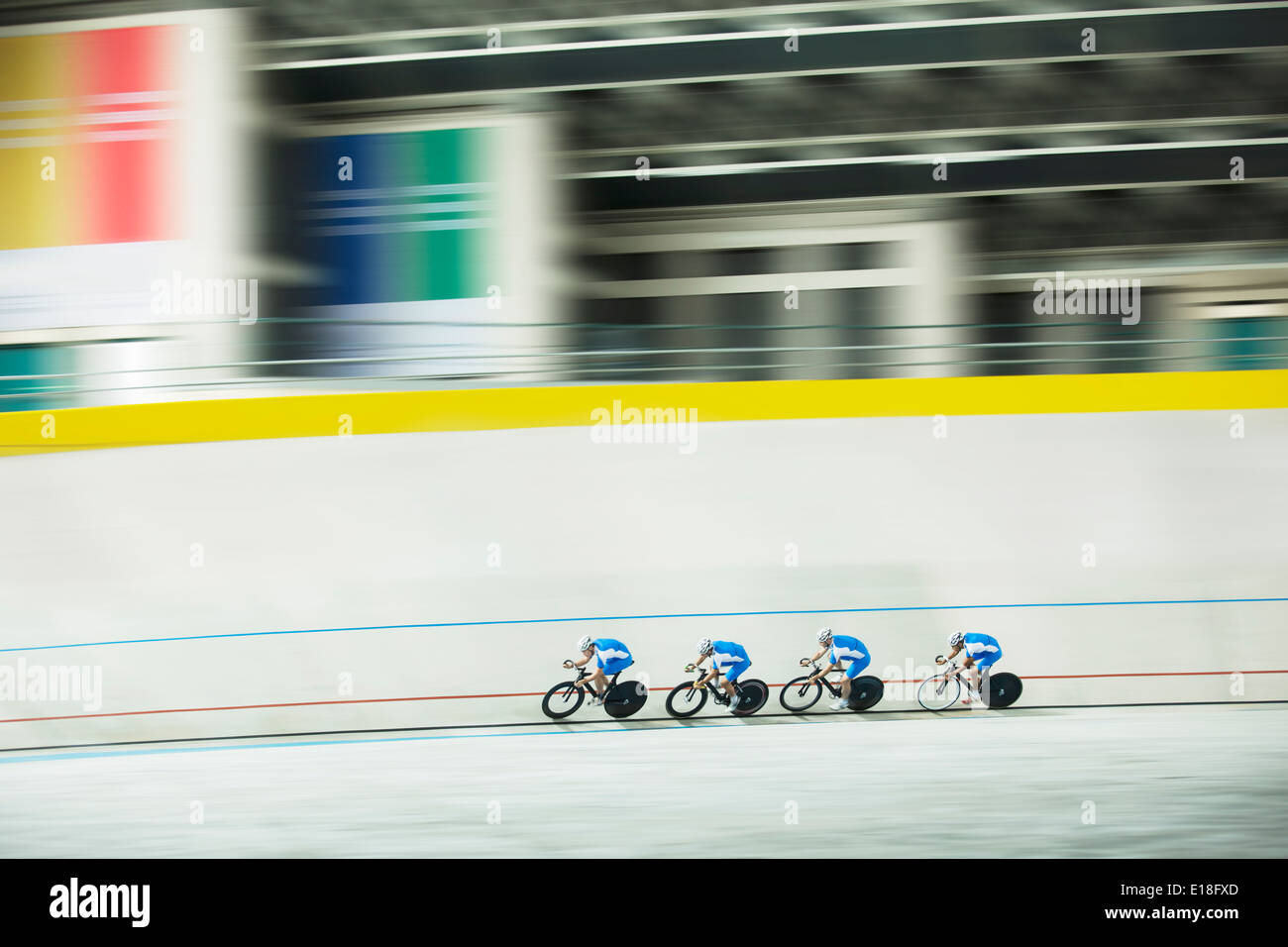 Track cycling team racing in velodrome Stock Photo