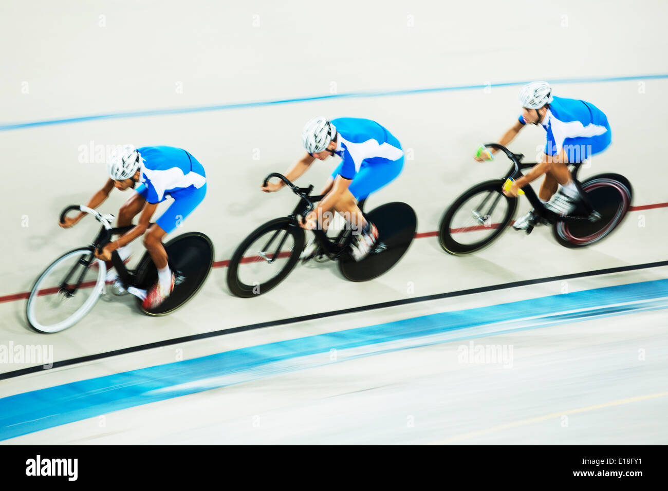 Track cycling team racing in velodrome Stock Photo