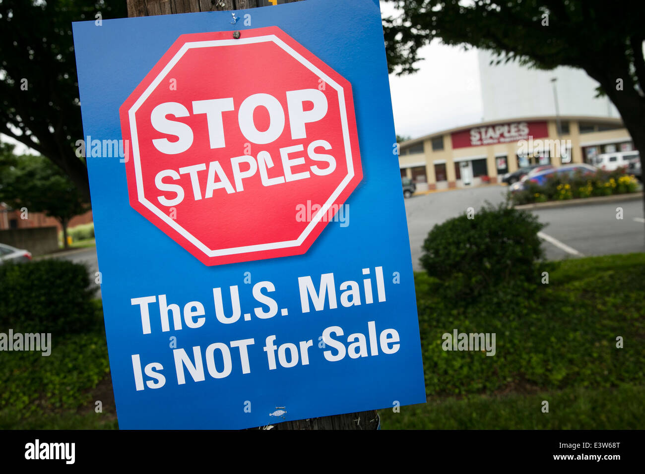 A sign protesting the opening of contract United States Post Office branches inside of Staples retail stores in Silver, Maryland. Stock Photo