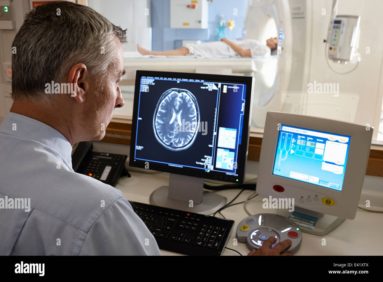 Radiologist looking at brain scan image on computer screen Stock Photo