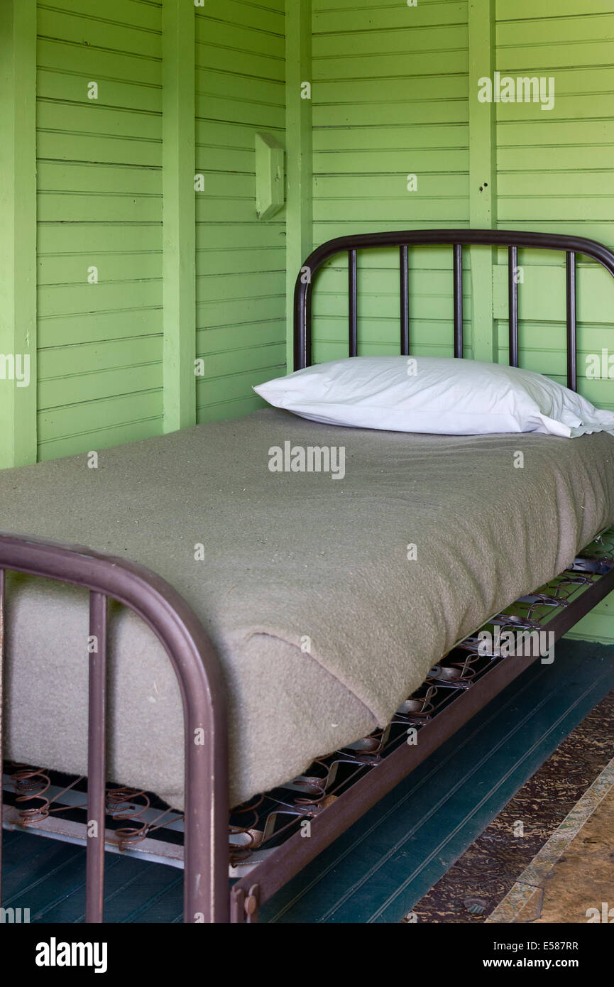 Simple bed in basic room. Stock Photo