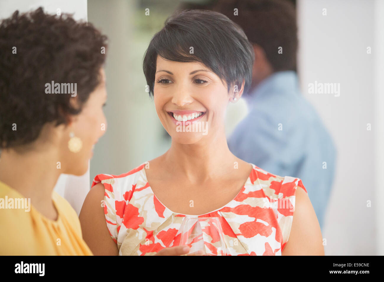 Women talking at party Stock Photo