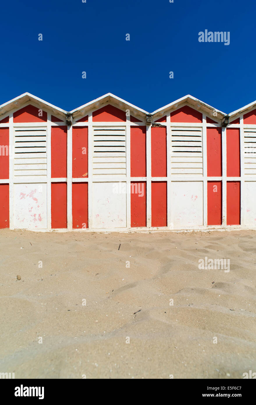 Red wooden cabins on the beach. Stock Photo