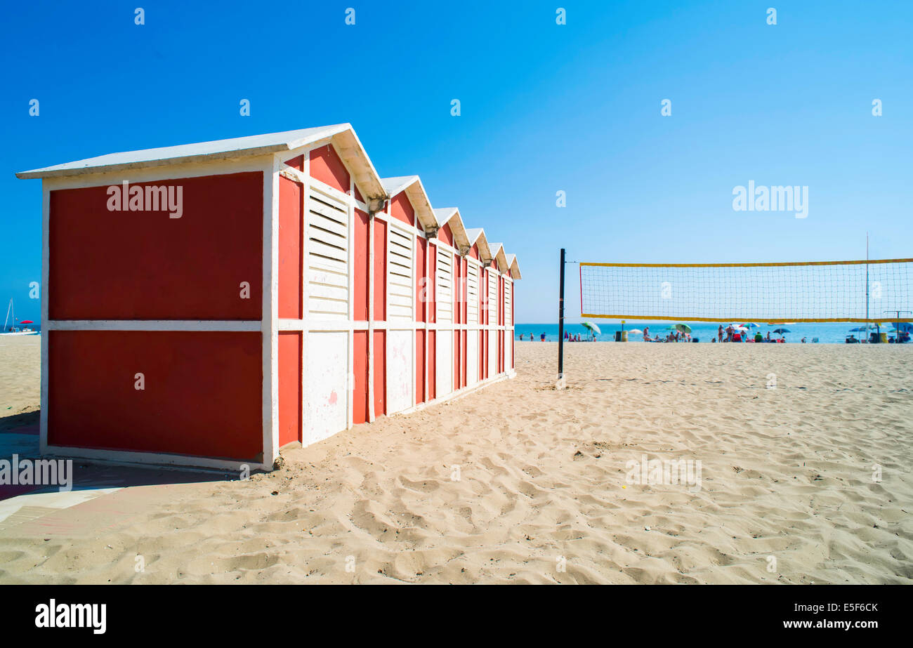 Red wooden cabins on the beach. Stock Photo