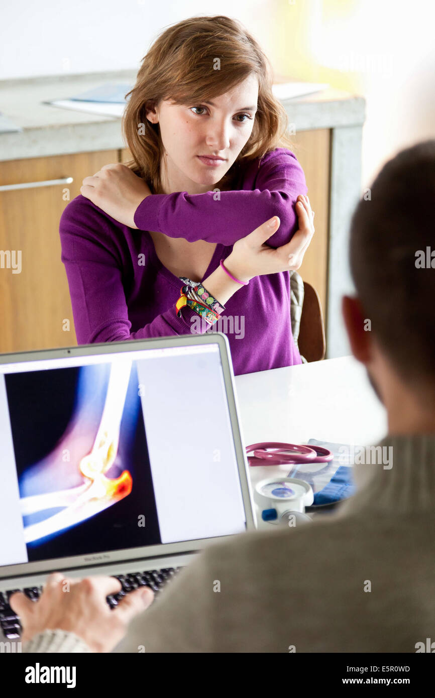 Woman consulting for elbow pain. Stock Photo