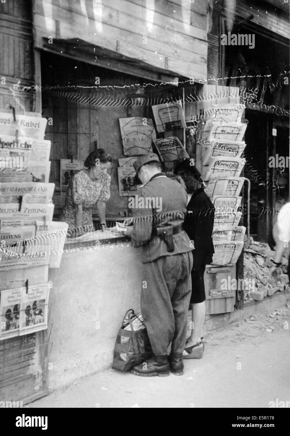 The picture from a Nazi news report shows a newsstand next to a destroyed building in Berlin, Germany, October 1944. The original text on the back of the picture reads: 'Life in Berlin today - The newsstands still sell newspapers from all over the world. Just like before, Berlin is still the intellectual center of Europe's news service.' Fotoarchiv für Zeitgeschichte - NO WIRE SERVICE Stock Photo