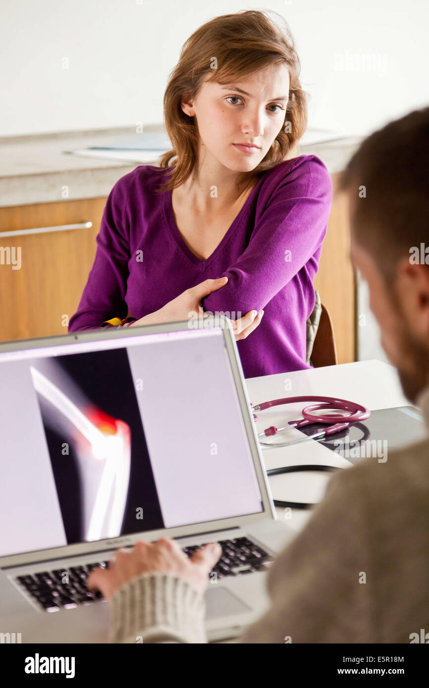 Woman consulting for elbow pain. Stock Photo