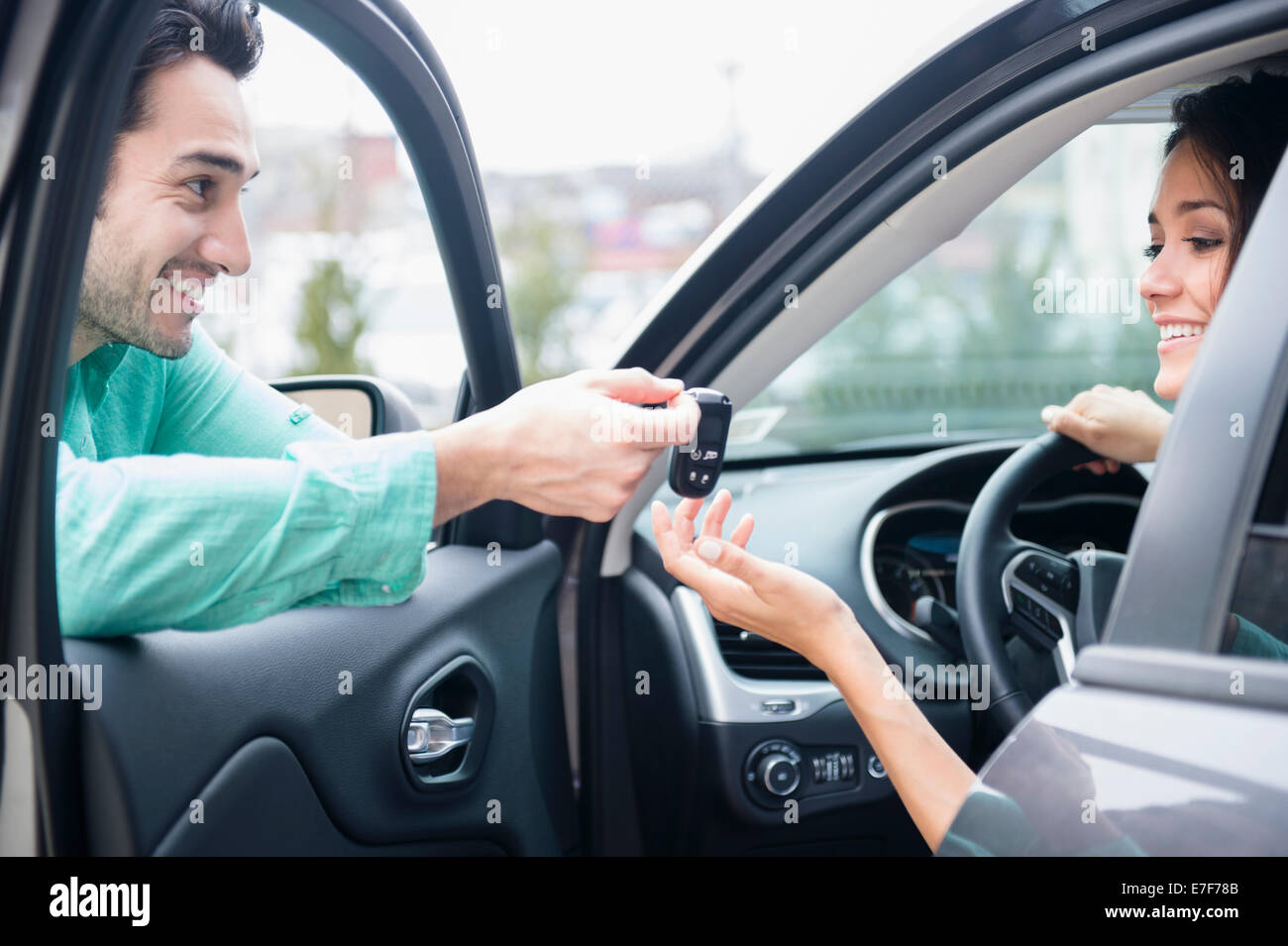 Man giving girlfriend keys to car Stock Photo