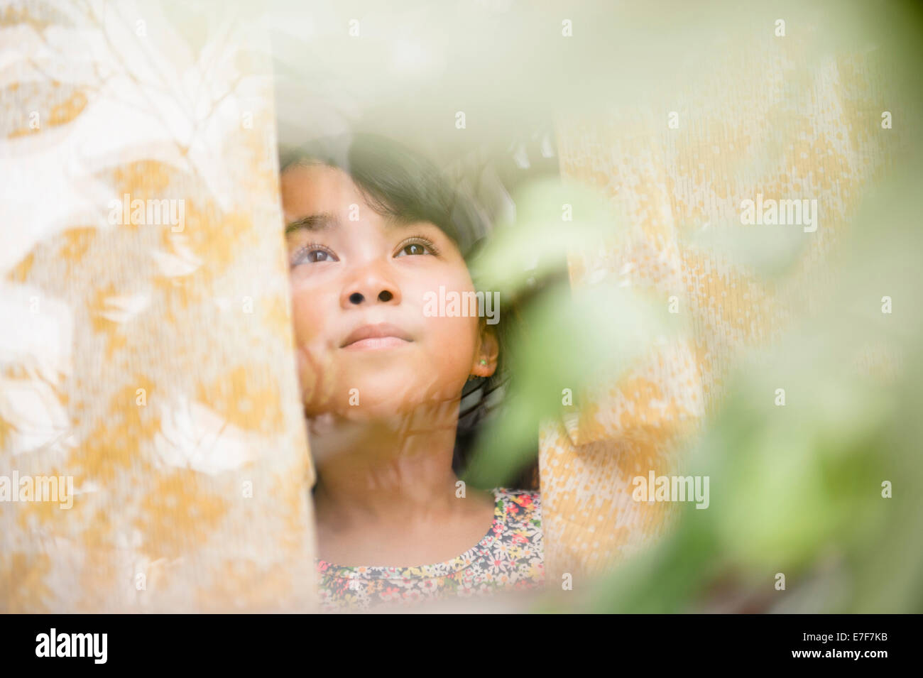 Filipino girl looking out window Stock Photo