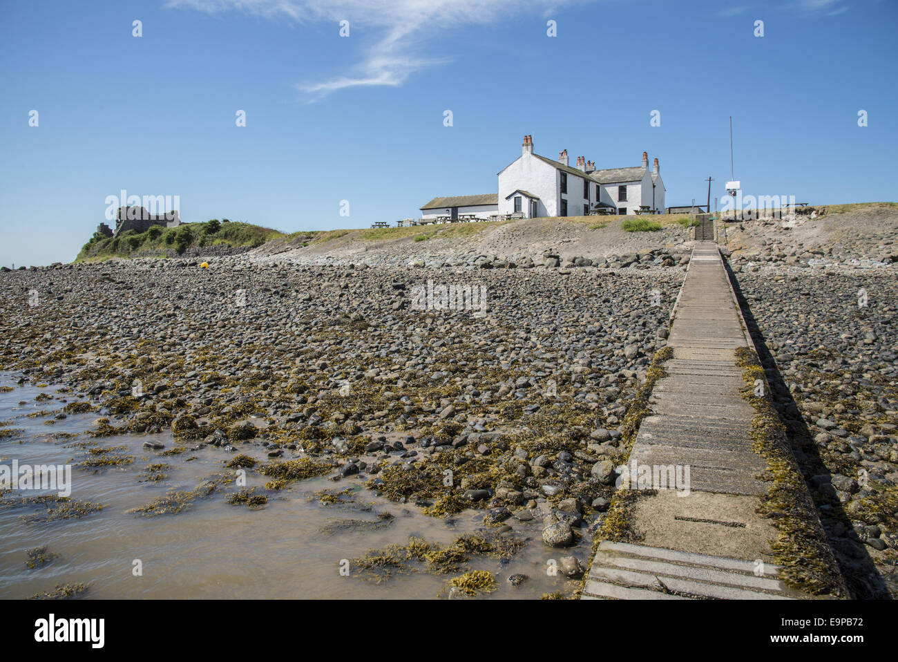 View of causeway and 18th century public house near coast, The Ship Inn, Piel Channel, Piel Island, Islands of Furness, Barrow-in-Furness, Cumbria, England, July Stock Photo