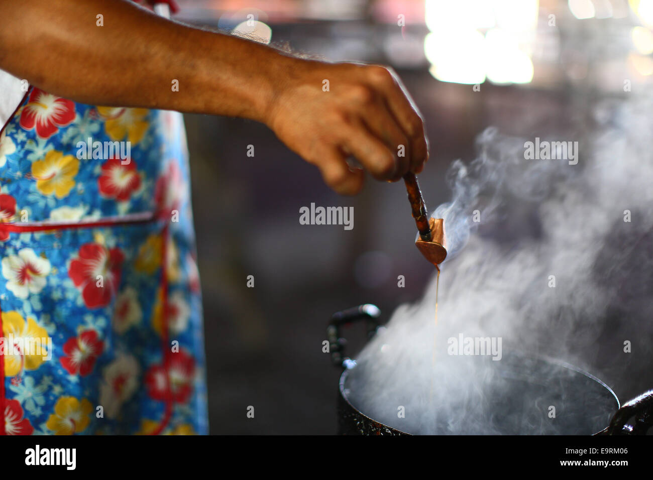 Preparing the melting wax for Batik Chanting traditional painting. Stock Photo