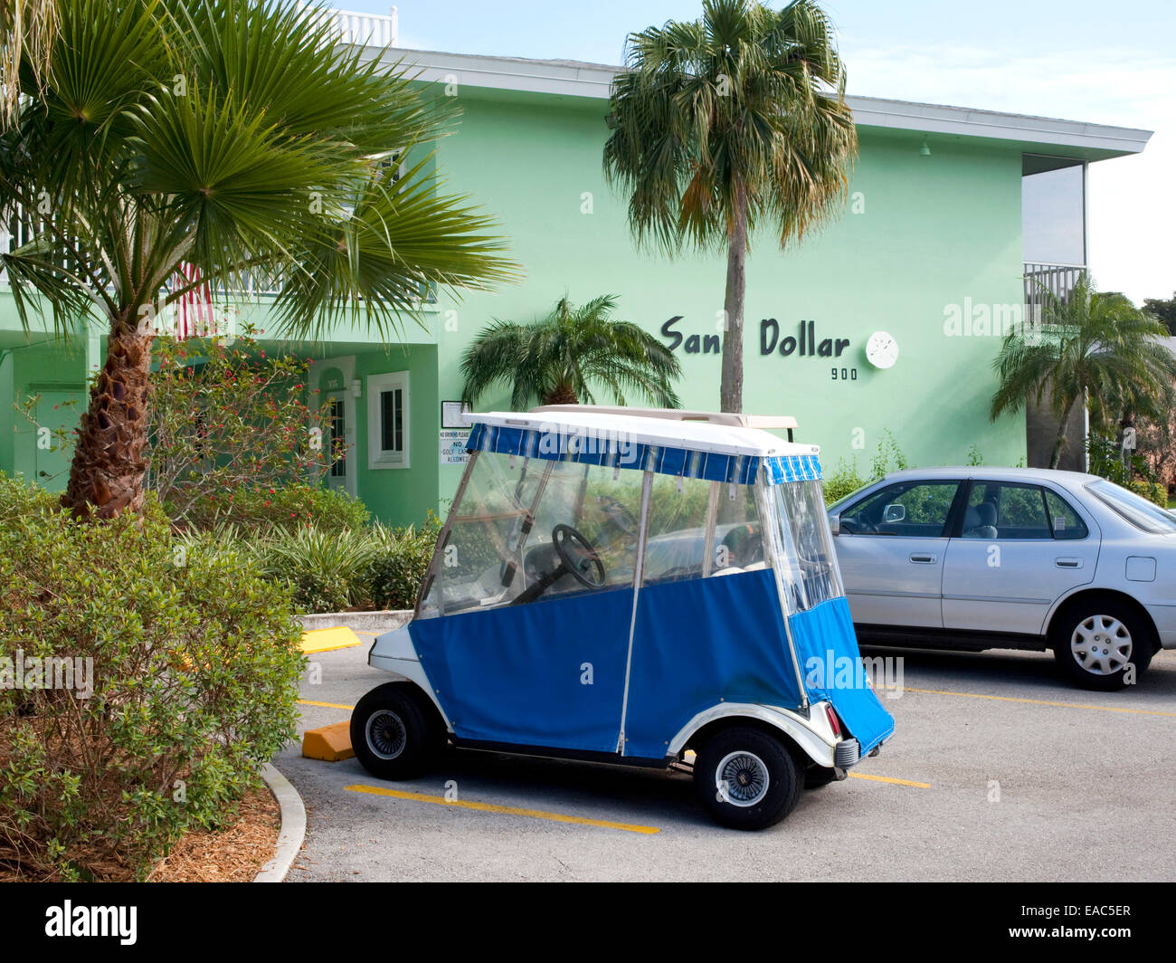 Covered golf cart in motel parking lot Stock Photo