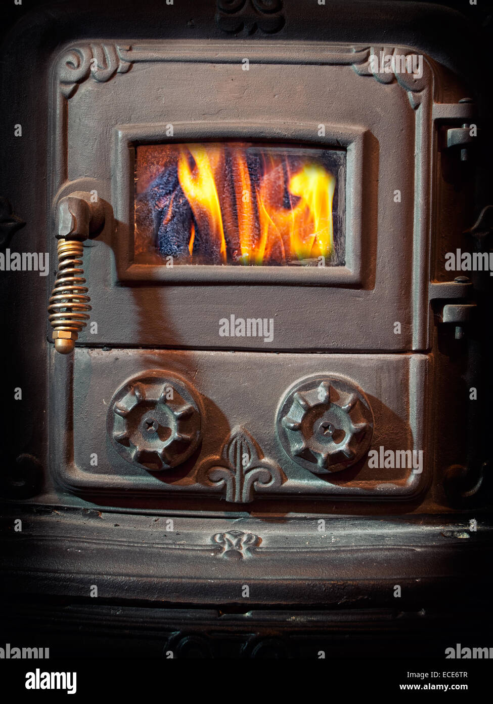 Firebox door of a retro wood burning stove. Stock Photo