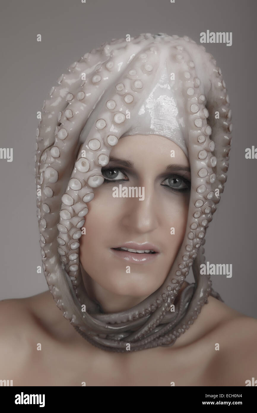 young woman with octopus on head Stock Photo