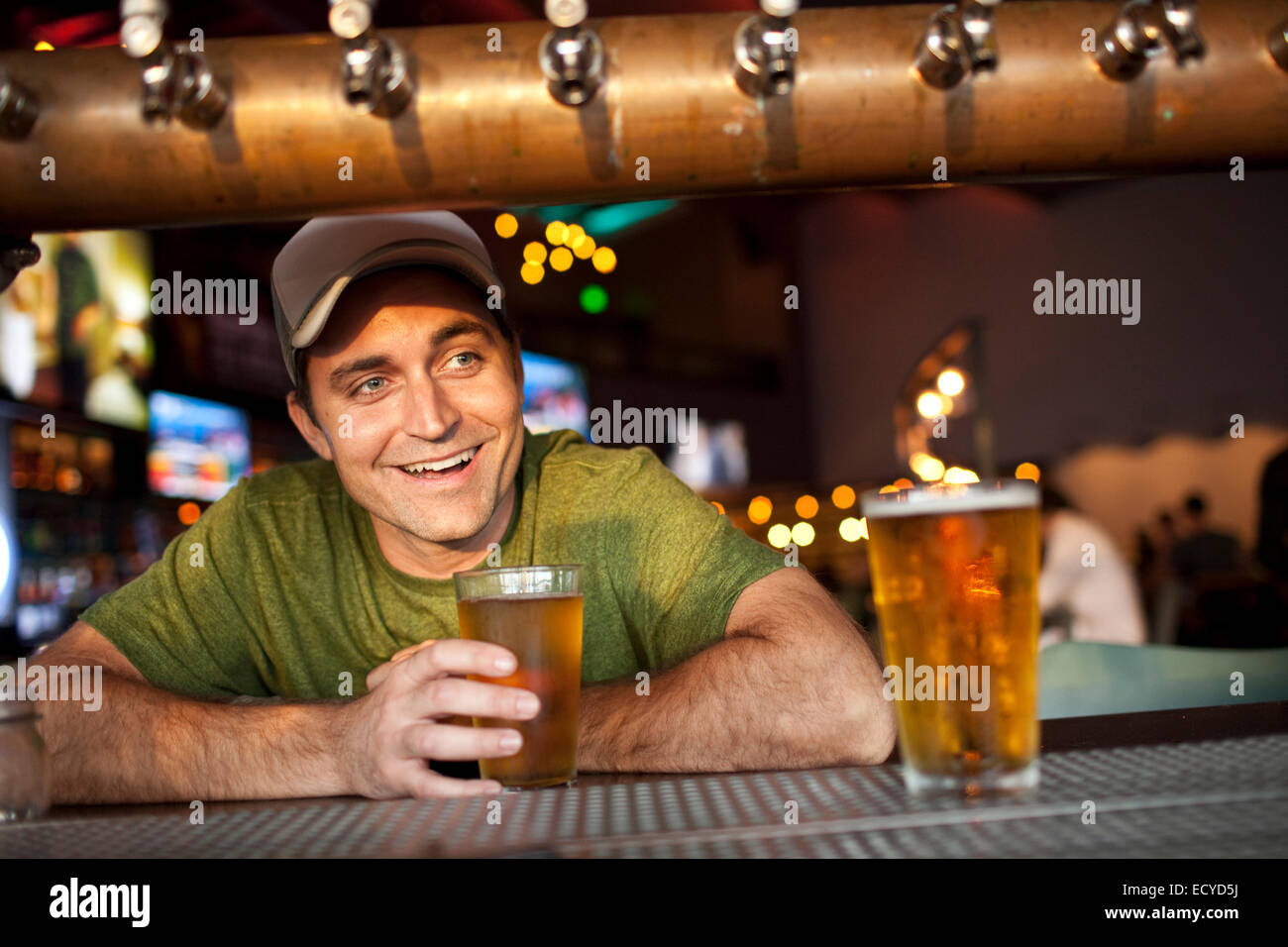 Caucasian man drinking beer in bar Stock Photo