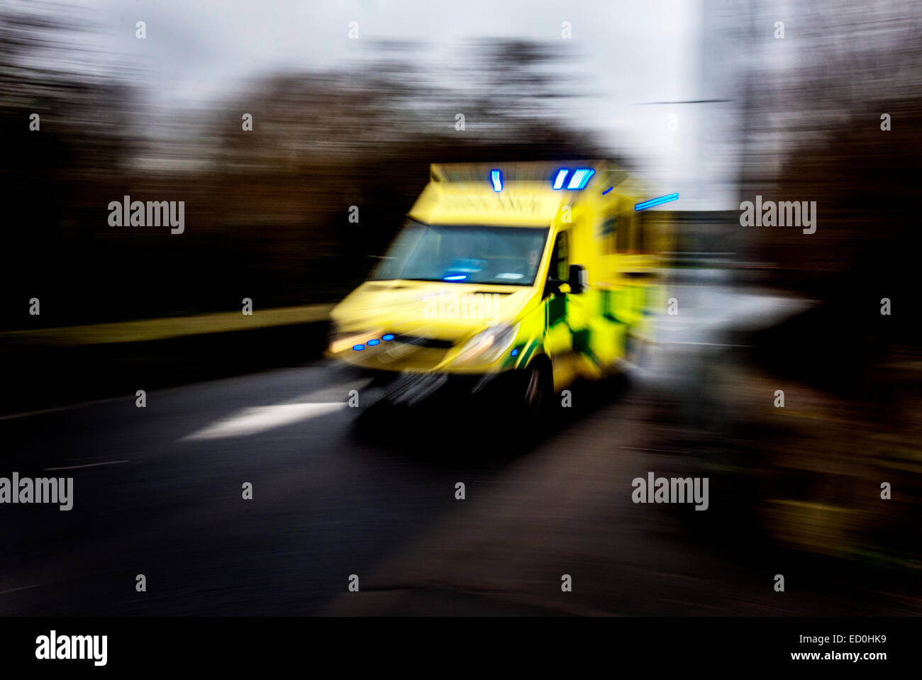 Fast moving ambulance responding to an emergency image showing speed blur. Stock Photo