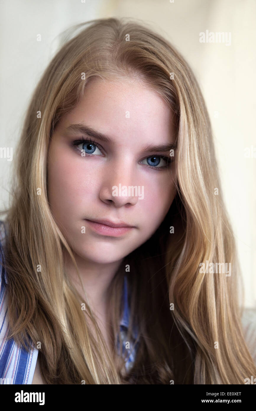 Portrait of a young teenage woman looking into the camera with a serious expression on her face. Stock Photo