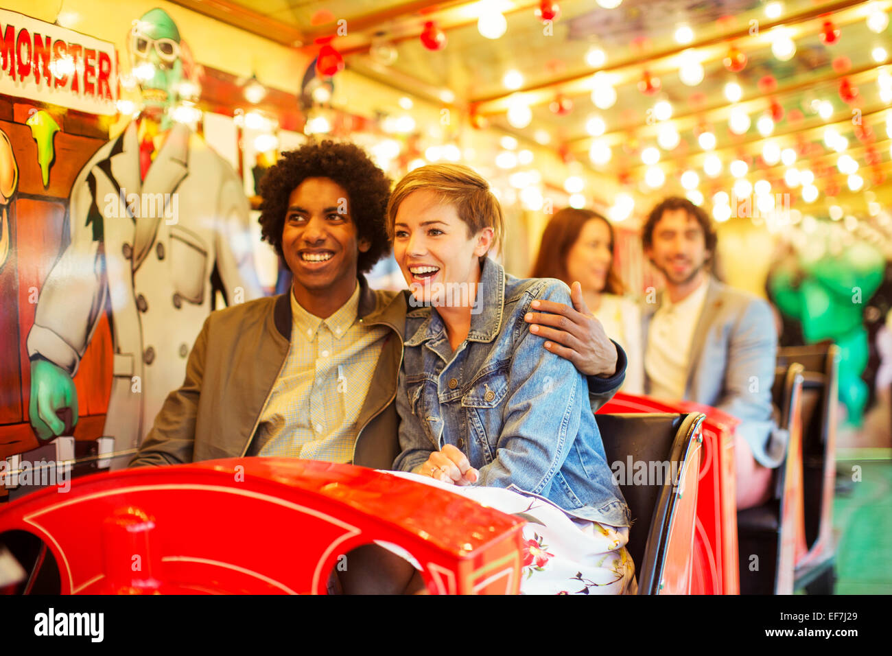 Man embracing girlfriend on ghost train Stock Photo