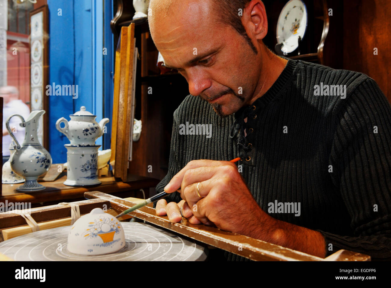 Painting faiences in an atelier in Rouen, Seine-Maritime, Normandy, France Stock Photo