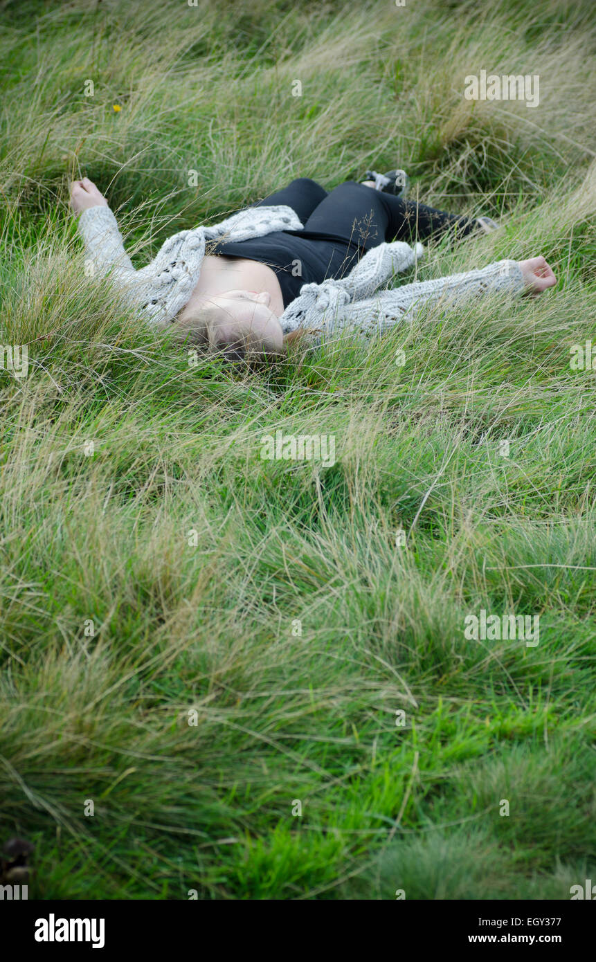 Dead woman on the grass Stock Photo