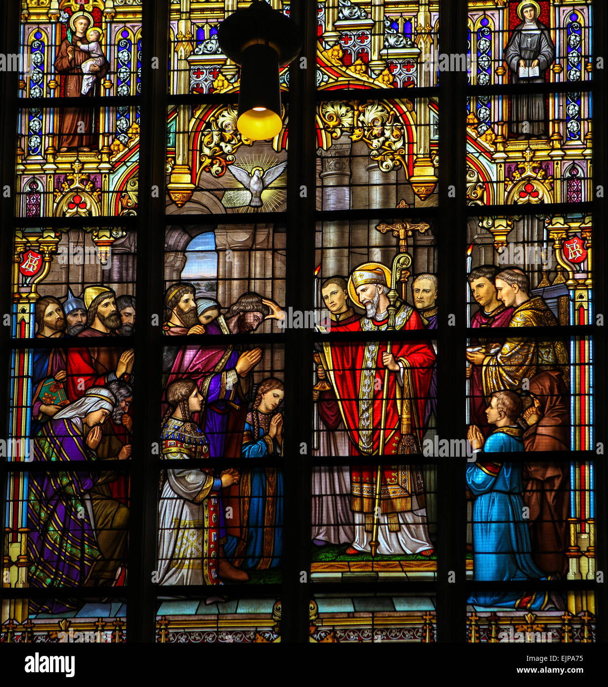 Stained Glass Window depicting Saint Lambertus anointing the Taxandrians during the Confirmation, the rite of initiation. Stock Photo