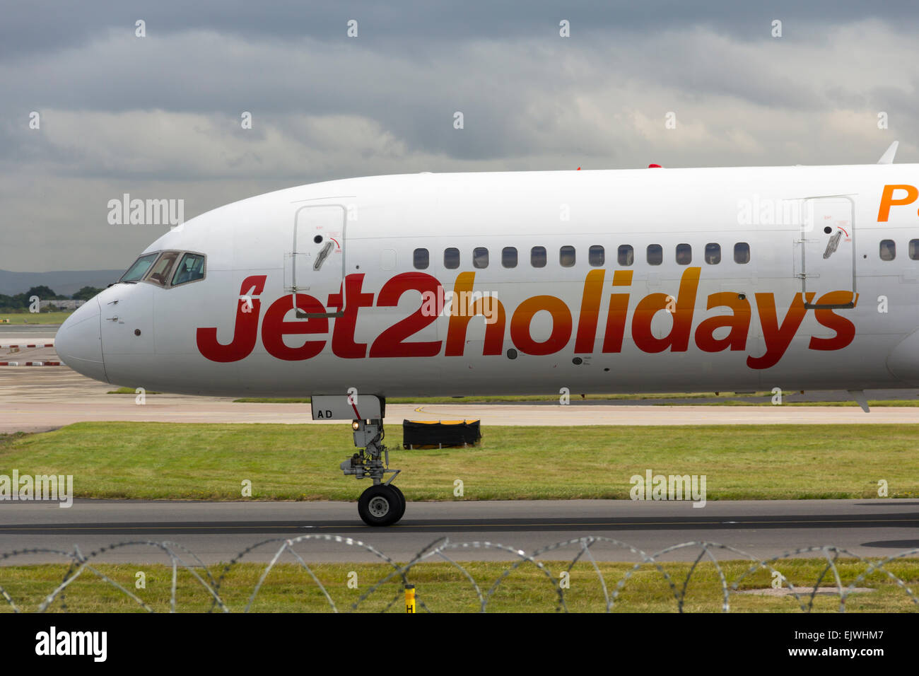 Jet2holidays branded aircraft taxiing towards the terminal at Manchester airport shortly after landing. Stock Photo