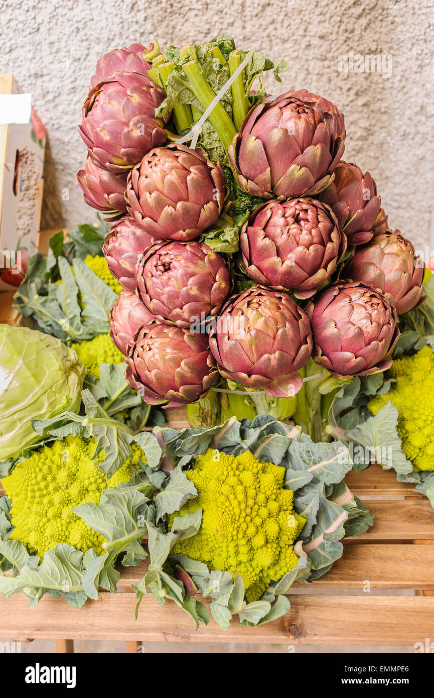 Artichokes and cabbages for sale at the local market Stock Photo