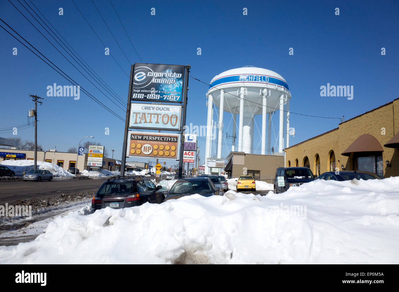 Penn Avenue bordered by a plethora of shops and the city water tower. Richfield Minnesota MN USA Stock Photo