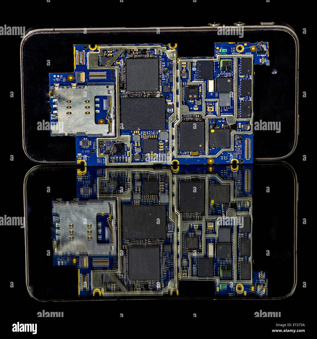 Electronics of a smart phone on top of it Stock Photo