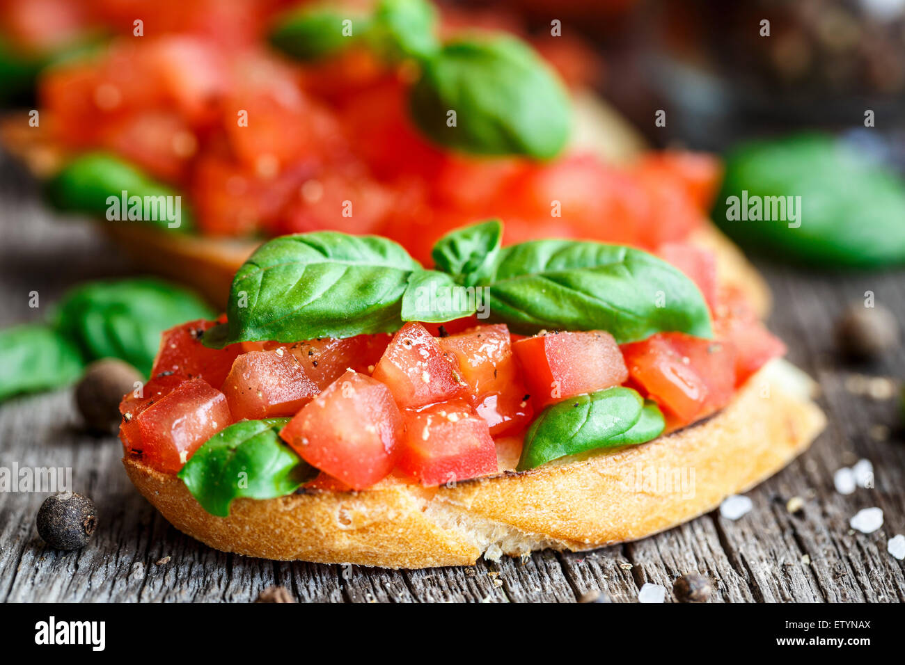 Tomato bruschetta with chopped tomatoes and basil on toasted bread Stock Photo