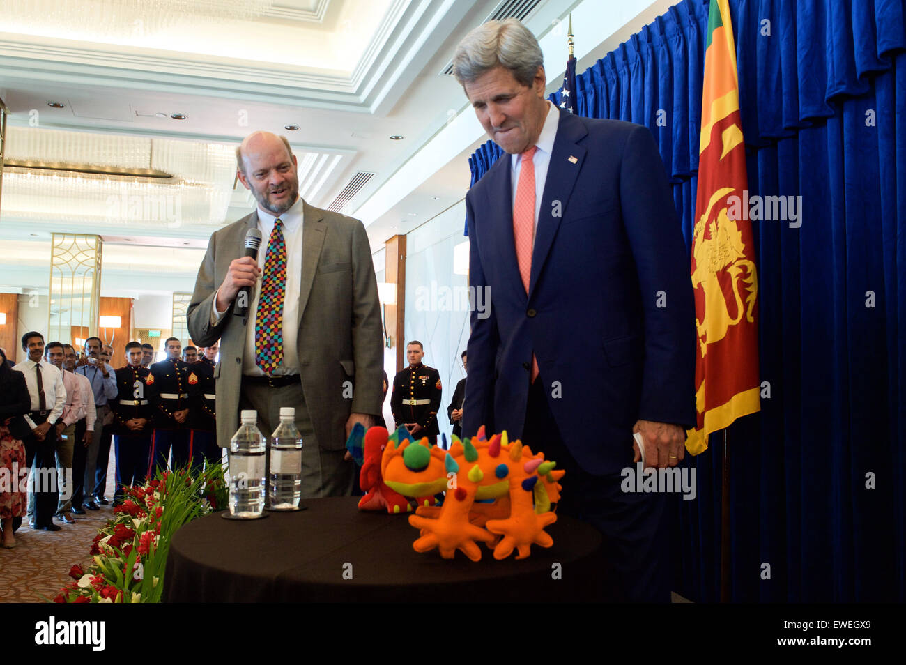 U.S. Charge d’Affaires Andrew Mann presents U.S. Secretary of State John Kerry with toys for his grandchildren before the Secretary addressed employees and family members from U.S. Embassy Sri Lanka on May 3, 2015, in Colombo, Sri Lanka. Stock Photo