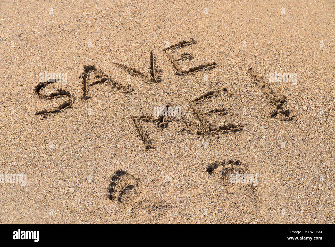 Save Me Sign Drawn On Beach Sand Stock Photo