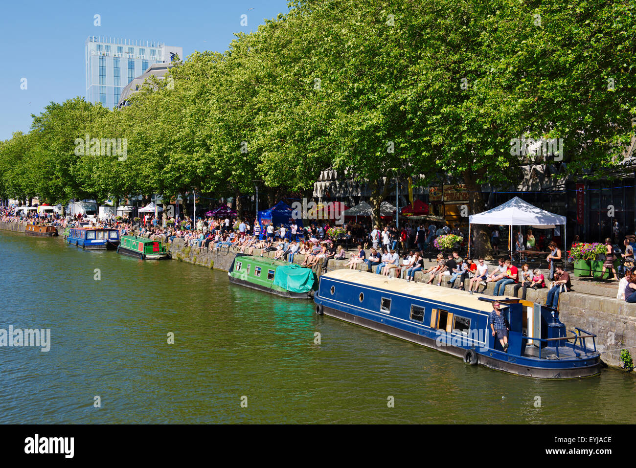 Visiting people and canal boats along Narrow Quay of St Augustine's Reach of Bristol floating harbour during harbour festival Stock Photo