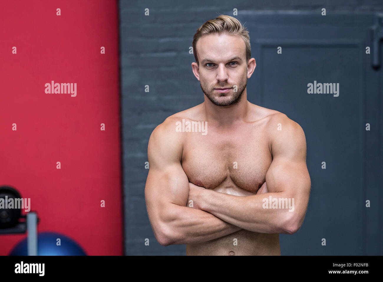 Muscular man with arms crossed Stock Photo