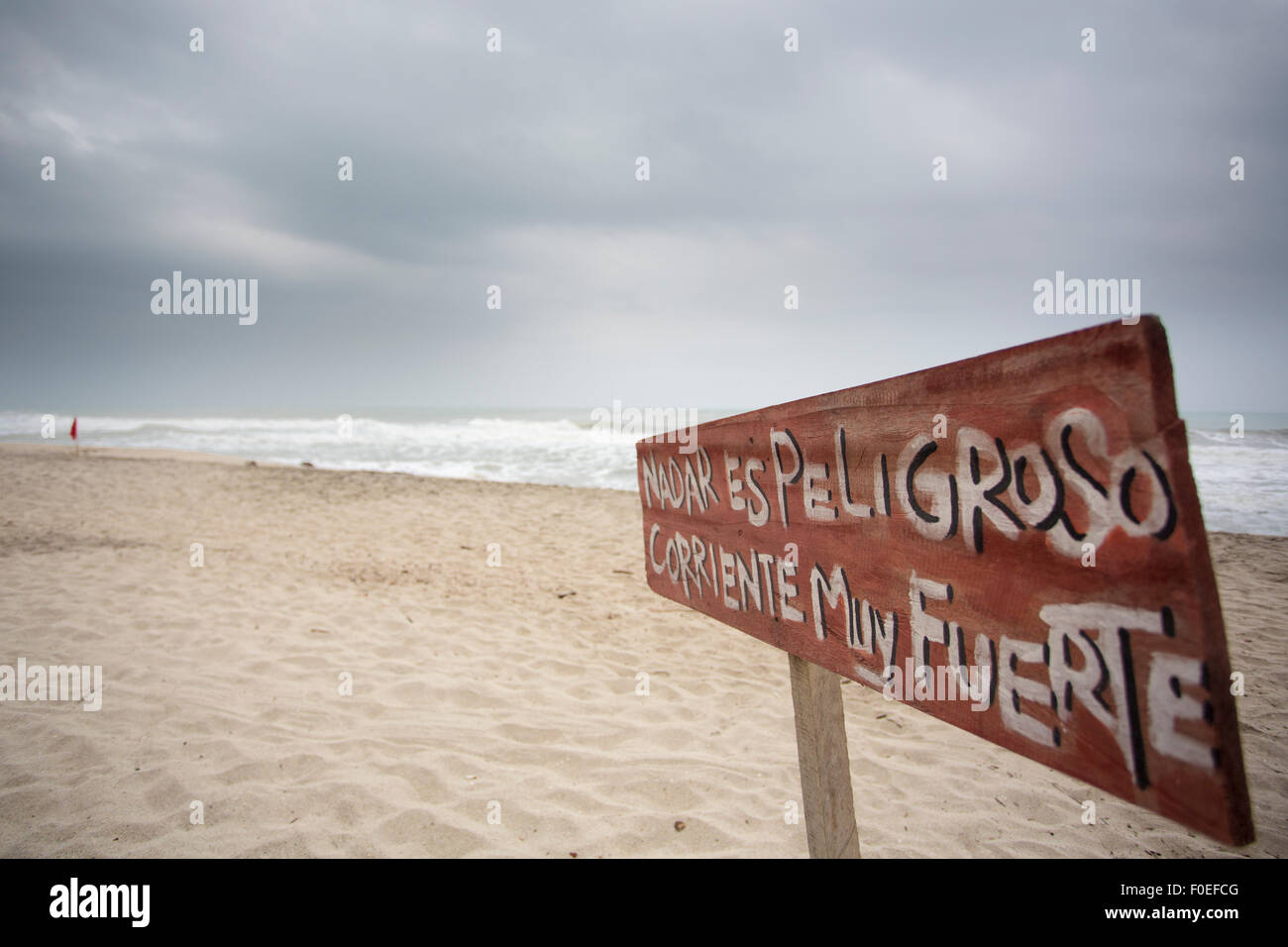 Sign in Spanish stating that it is dangerous to swim in Palomino, Colombia. Stock Photo