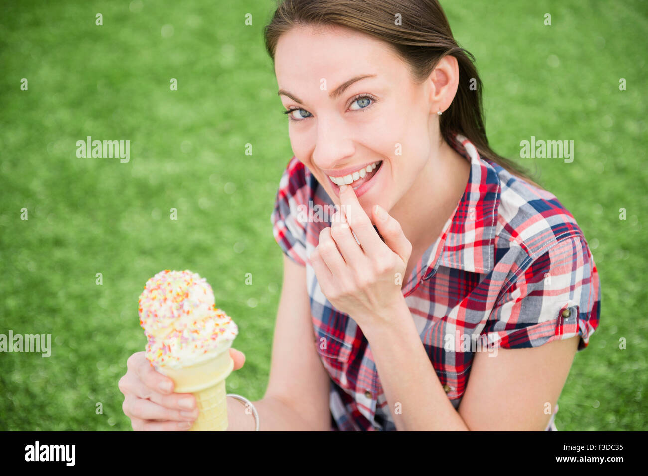 Portrait of woman eating ice cream cone Stock Photo