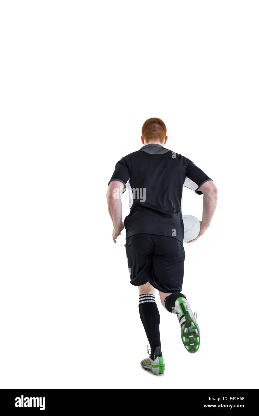 Rugby player running with a rugby ball Stock Photo