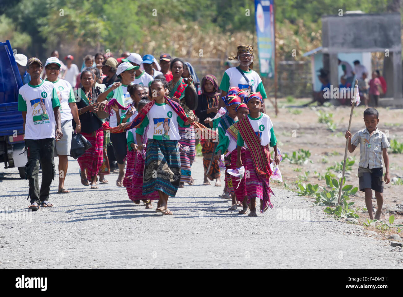 East Timorese children and chief wearing traditional clothes while heading to perform at an electoral campaign event in 2012 Stock Photo