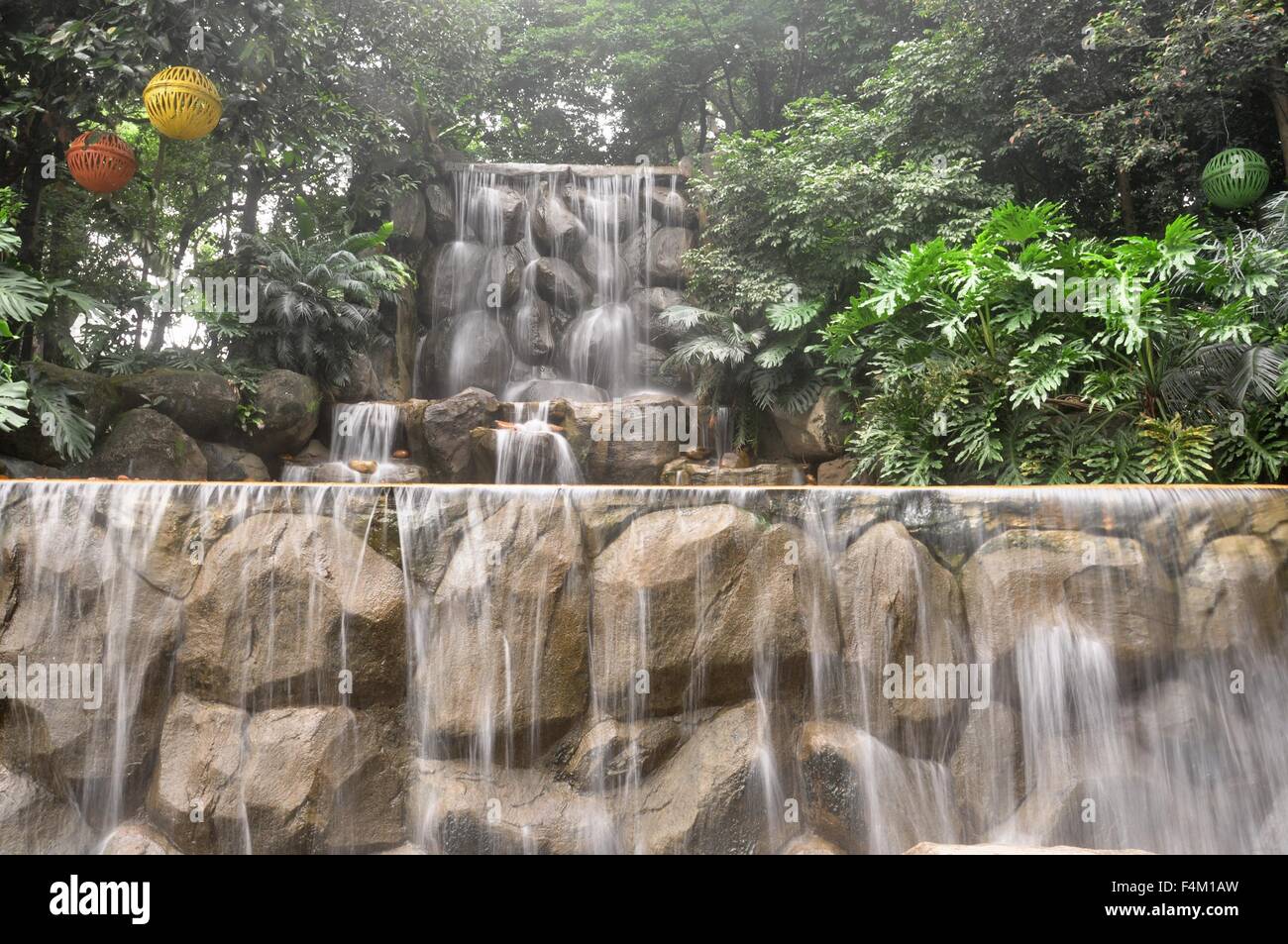 beautiful man-made waterfall in the park Stock Photo