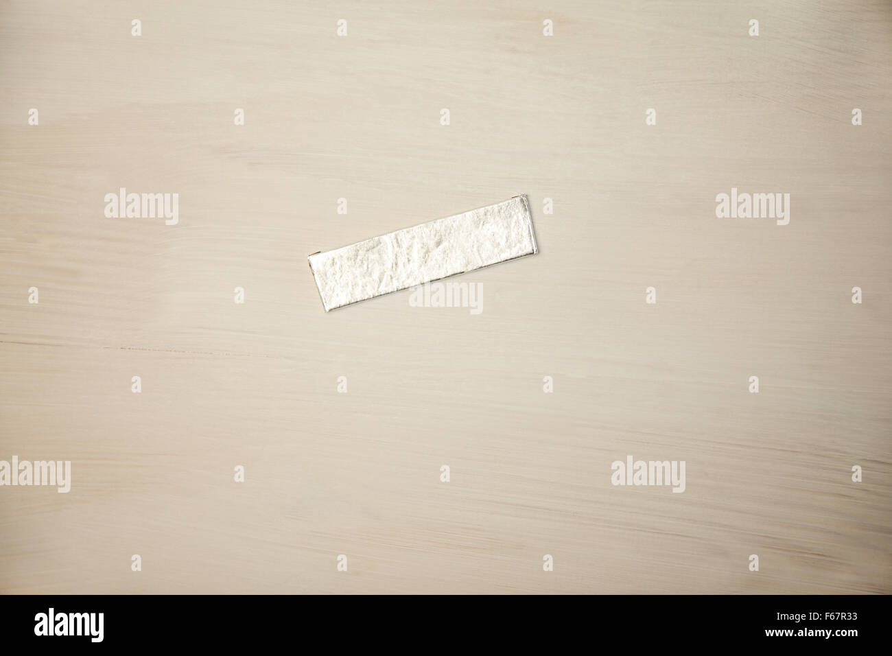 Chewing gum wrapper on wooden desk Stock Photo