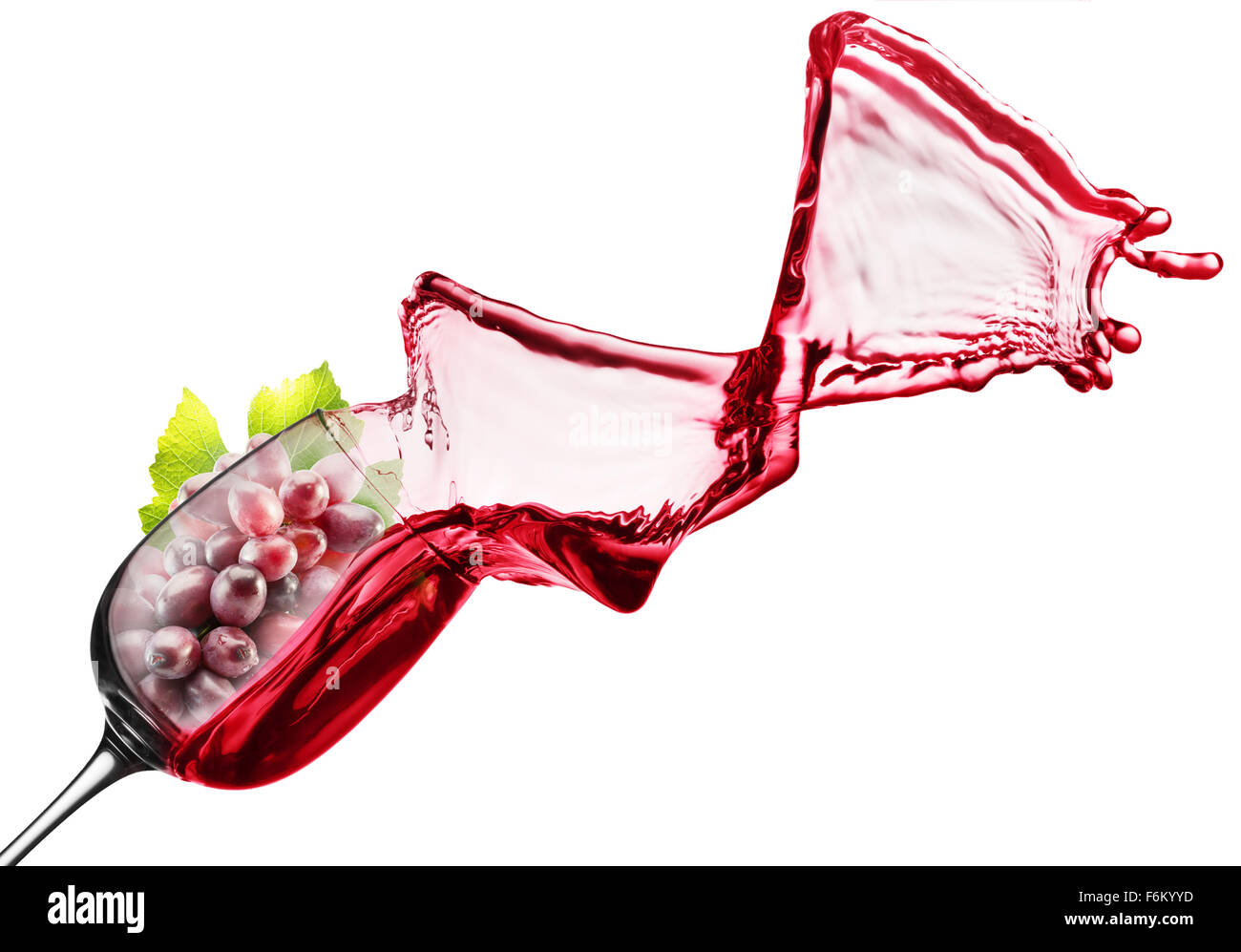 red wine splash with pink grape in glass. Stock Photo